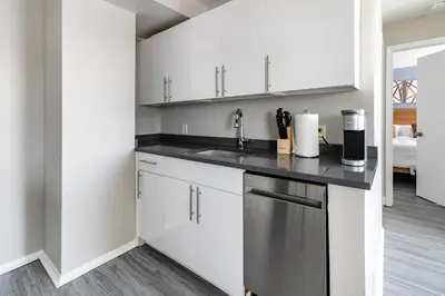 a kitchen with white cabinets and a sink at Landing Stylish 1BD Gym in New Haven