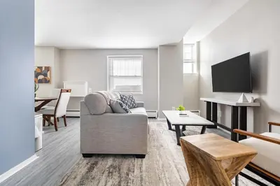 a living room with a couch and a tv at Landing Stylish 1BD Gym in New Haven