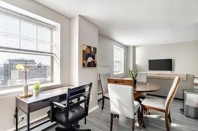 a living room with a desk and a dining room at Landing Stylish 1BD Gym in New Haven