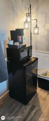 a kitchen with a microwave on top of a counter at Windmill Motel Restaurant in Bernardston
