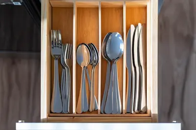 a wooden holder with silver utensils in it at New home, 17 min to NYC, 5 min to MetLife Stadium in Carlstadt