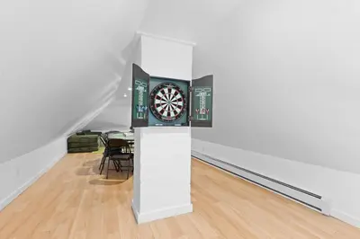 a room with a dart board on a wall at New home, 17 min to NYC, 5 min to MetLife Stadium in Carlstadt