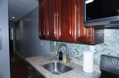 a kitchen with a sink and a microwave at New York private room 31 in West New York