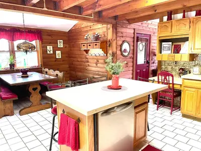 a kitchen with a table and a counter in a room at Log Cabin at the Goat Sanctuary in Napanoch