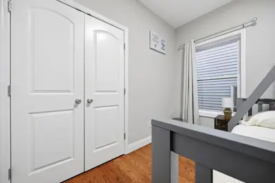a bedroom with a white closet and a bed at Sleeps 19 • 15ft Celings • Near NYC in Jersey City