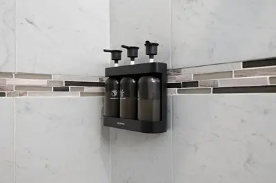 a soap dispenser on a wall in a bathroom at Sleeps 19 • 15ft Celings • Near NYC in Jersey City