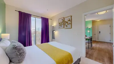 a bedroom with a large bed with purple curtains at Stylish Home With Free ParkingFA in Stamford