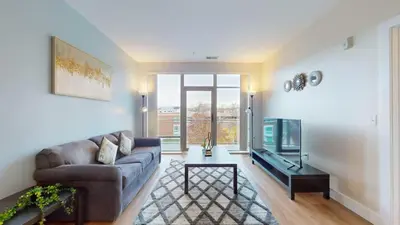 a living room with a couch and a tv at Stylish Home With Free ParkingZA in Stamford