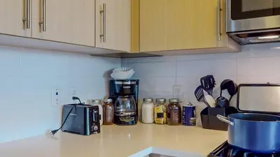 a kitchen counter with a coffee pot on a counter top at Stylish Home With Free ParkingZA in Stamford