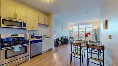 a kitchen with a stove and a table with chairs at Stylish Home With Free ParkingZA in Stamford