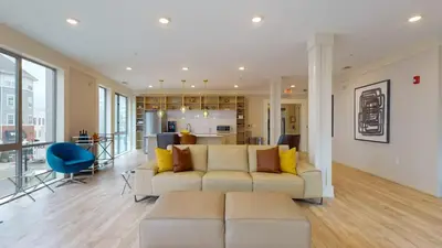 a living room with a white couch and a blue chair at Stylish Home with Free Parking in Stamford