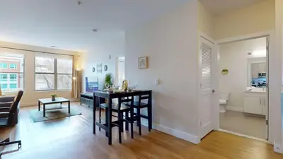 a kitchen and living room with a table and chairs at Stylish Home with Free Parking in Stamford