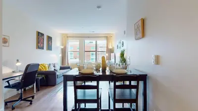 a dining room and living room with a table and chairs at Stylish Home with Free Parking in Stamford
