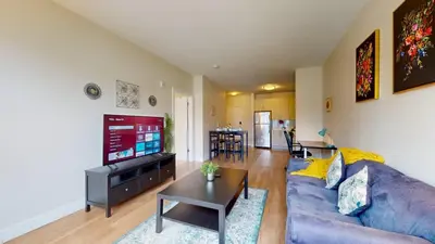a living room with a couch and a tv at Stylish Home with Free Parking in Stamford