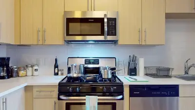 a kitchen with a stove and a microwave at Stylish Home with Free Parking in Stamford