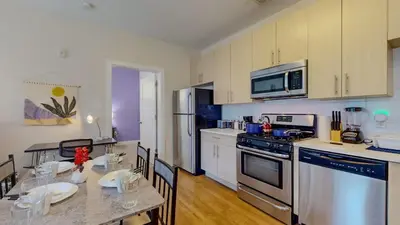 a kitchen with a table and a dining room at Stylish Home and Cozy in Stamford