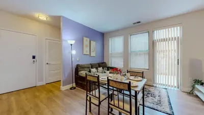 a living room with a table and a couch at Stylish Home and Cozy in Stamford