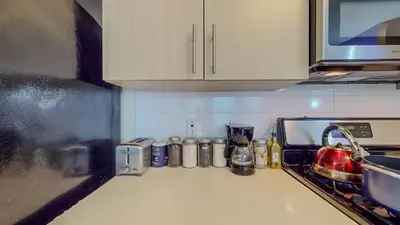 a kitchen with a sink and a counter top at Stylish Home and Cozy in Stamford