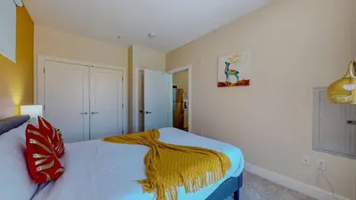 a bedroom with a bed with a blanket on it at Stylish Home and Cozy200 in Stamford