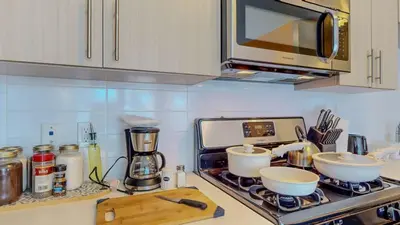 a kitchen with a stove with two bowls and a microwave at Stylish Home and Cozy200 in Stamford