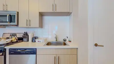 a kitchen with a sink and a microwave at Stylish Home and Cozy200 in Stamford