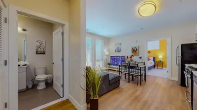 a living room with a kitchen and a dining room at Stylish Home and Cozy200 in Stamford