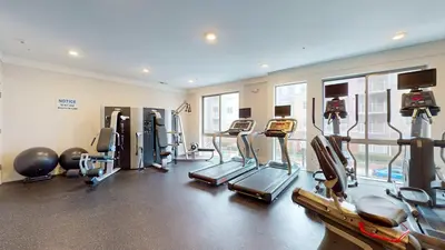 a gym with several treadmills and exercise machines at Comfort Meets Convenience Parking Gym near NYC in Stamford