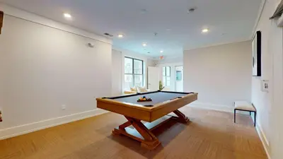 a room with a pool table in a room with a wall at Comfort Meets Convenience Parking Gym near NYC in Stamford