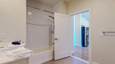 a bathroom with a shower and a tub and a sink at Comfort Meets Convenience Parking Gym near NYC in Stamford