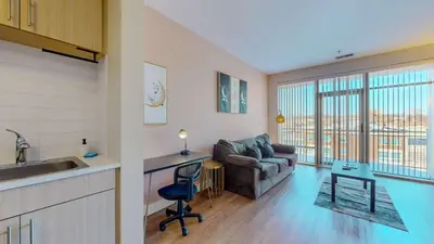 a kitchen and a living room with a couch at Comfort Meets Convenience Parking Gym near NYC in Stamford