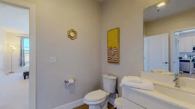 a bathroom with a toilet and a sink and a mirror at Comfort Meets Convenience Parking Gym near NYC in Stamford