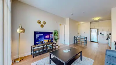 a living room with a table and a tv in it at Great Charming stay in Stamford