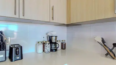 a kitchen counter with a coffee maker on a counter top at Great Charming stay in Stamford