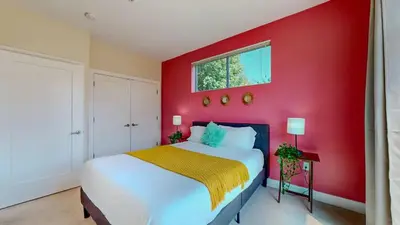 a red bedroom with a white bed and a red wall at Cozy Modern Home Free Parking in Stamford