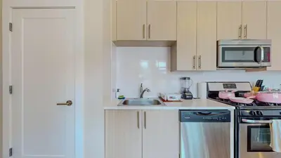a kitchen with a sink and a microwave at Cozy Modern Home Free Parking in Stamford