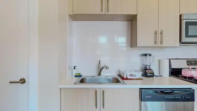 a kitchen with a sink and a microwave at Cozy Modern Home Free Parking in Stamford