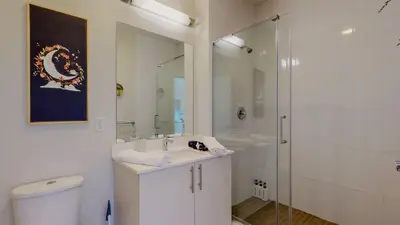a bathroom with a toilet and a sink and a shower at Cozy Modern Home Free Parking in Stamford