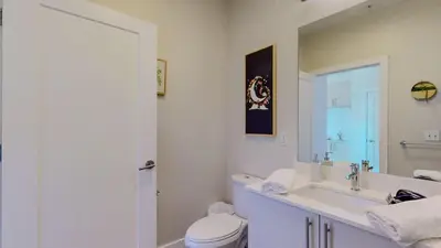 a white bathroom with a toilet and a sink at Cozy Modern Home Free Parking in Stamford