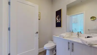 a white bathroom with a toilet and a sink at Cozy Modern Home Free Parking in Stamford