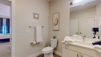 a bathroom with a toilet and a sink and a mirror at Elegant Home in Stamford