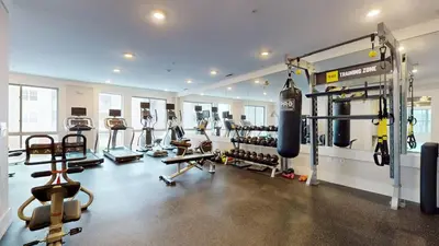 a gym with a bunch of equipment in a room at Elegant Home in Stamford