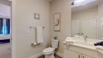 a bathroom with a toilet and a sink and a mirror at Elegant Home in Stamford