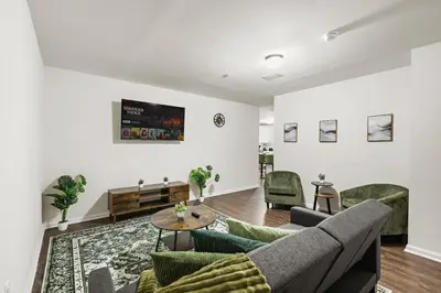 a living room with a couch and chairs and a table at Urban Haven XL - NYC & Newark with free parking in Newark