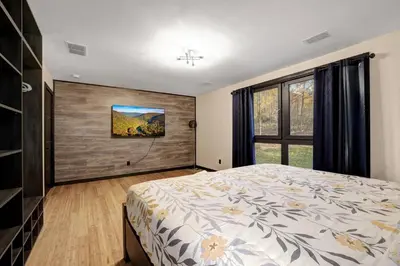 a bedroom with a large bed and a window at The Luxe Lodge Escape in Tannersville