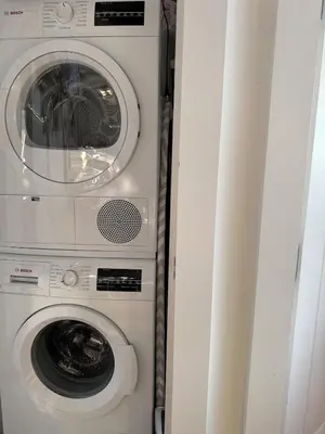 two washing machines sitting next to each other at Sky-High Sanctuary Penthouse with Panoramic Views in Brooklyn