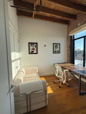 a living room with a table and a couch at Sky-High Sanctuary Penthouse with Panoramic Views in Brooklyn
