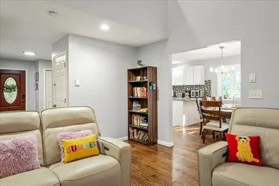 a living room with a couch and a dining room at Pocono Pride in East Stroudsburg