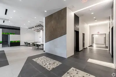 a lobby with a table and chairs in a building at Landing Chic 1BD Pool Game Room in Hartford