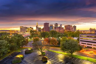 a city skyline at night with a street at Landing Chic 1BD Pool Game Room in Hartford