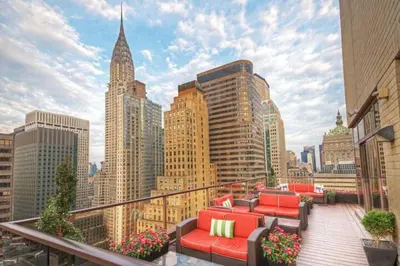 a balcony with red furniture and a city skyline at Club Wyndham Midtown 45 in New York
